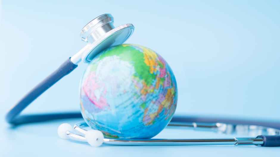 Image of a stethoscope resting on top of a globe