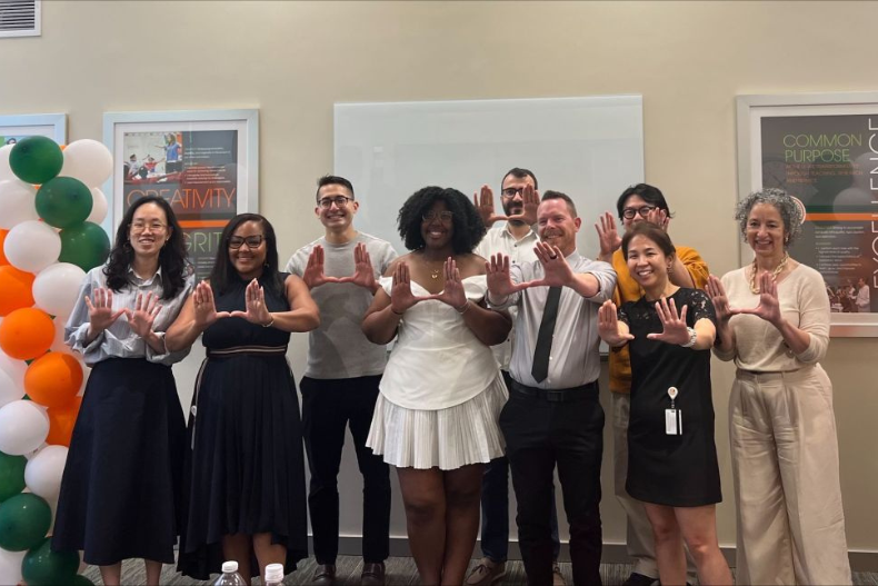 Soyeon Ahn and Dean Laura Kohn-Wood, far right, with members of the first graduating class of the online master’s in data analytics and program evaluation.
